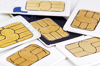 Close-up of scattered SIM cards on white background