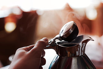 Hand Opening Steaming Silver Coffee Pot Close Up