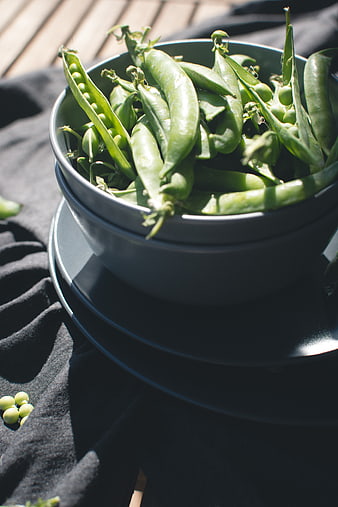 Fresh Green Peas in a Bowl on a Wooden Deck