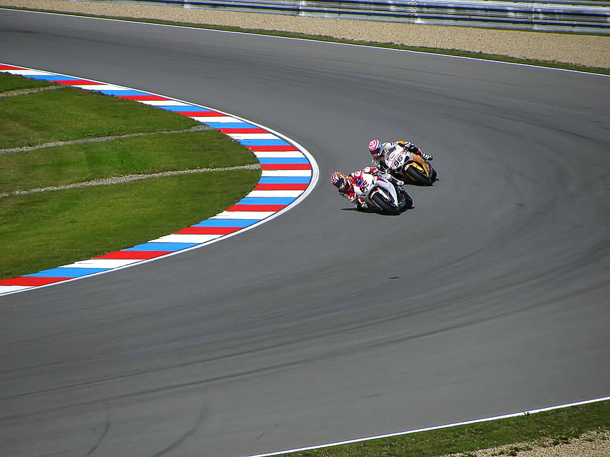 Two Motorcyclists Racing on a Curved Track