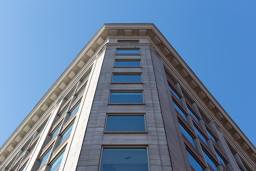 Low angle view of modern office building against blue sky