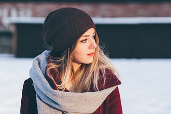 Winter Portrait of Woman in Knit Beanie and Scarf