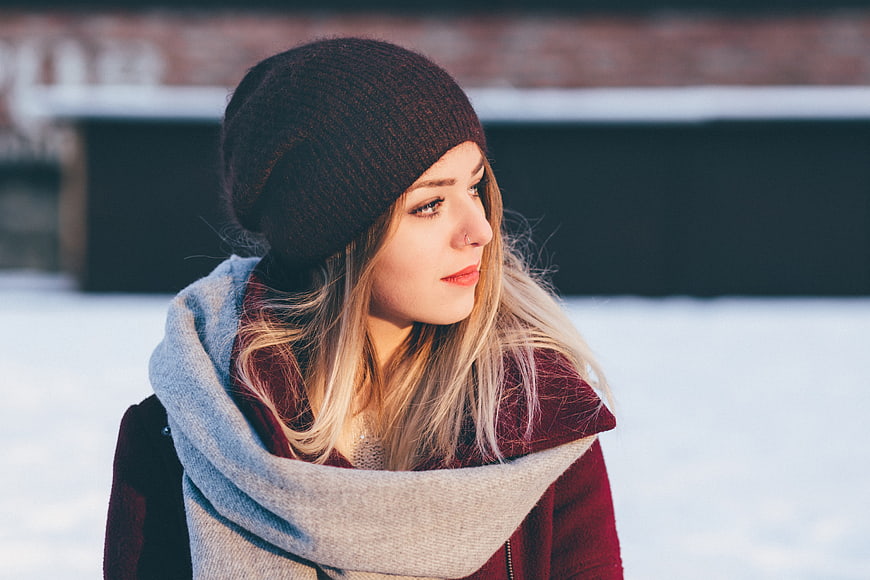Winter Portrait of Woman in Knit Beanie and Scarf