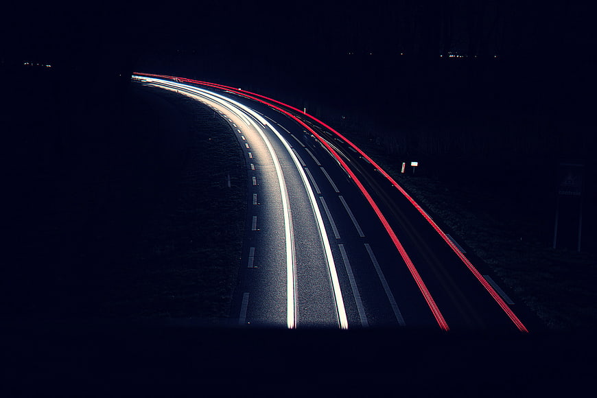 Long Exposure Light Trails on Curved Highway at Night