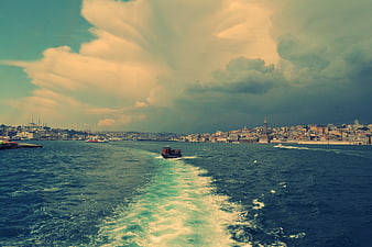Tugboat on Bosphorus with Istanbul Skyline and Dramatic Clouds