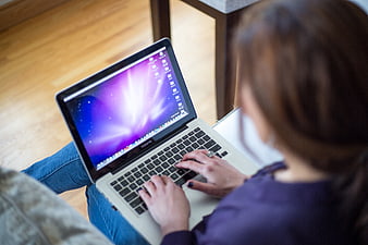 Woman Typing on Laptop in Casual Indoor Setting