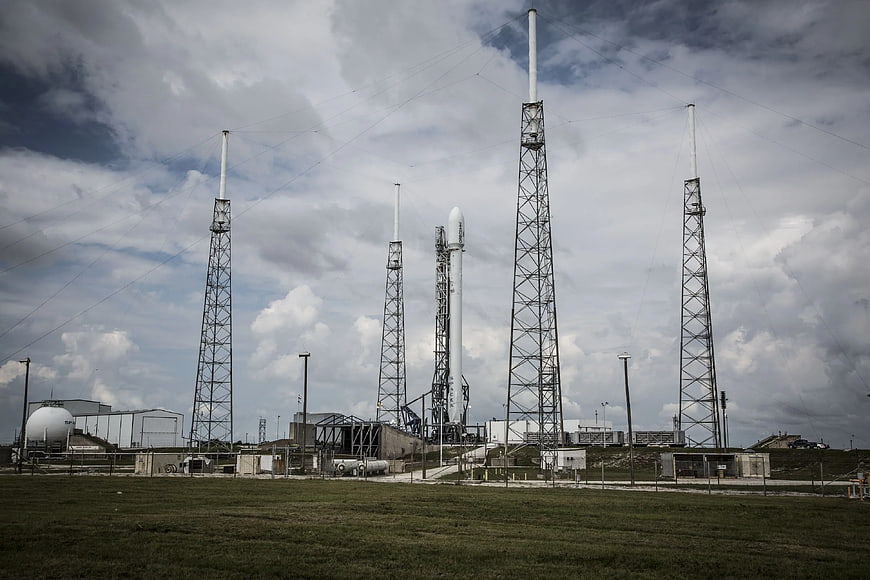 SpaceX Falcon 9 Rocket on Launch Pad with Lightning Towers
