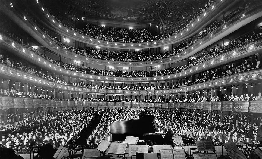 Vintage black and white photo of crowded opera house interior