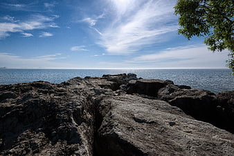 Rugged Rocky Coastline with Blue Ocean and Sky