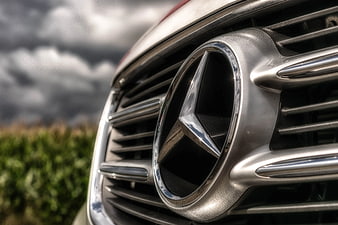Close-up of Mercedes-Benz Emblem on Car Grille