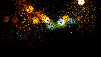 Abstract Bokeh Lights Through Raindrops on Glass