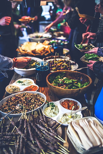 Buffet table with skewers, salads, and dips at a gathering