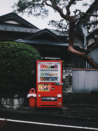 Red vending machine on quiet Japanese street