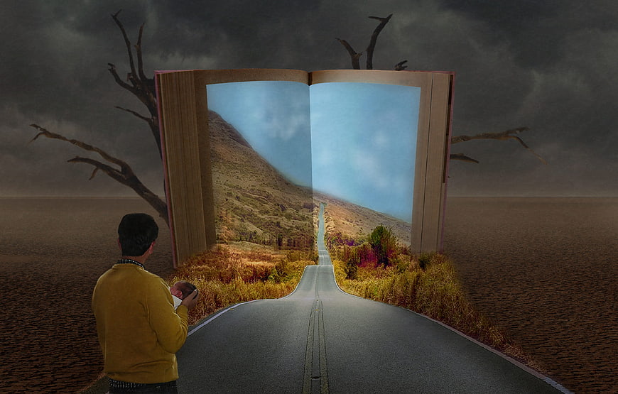 Father holding baby looking at giant open book with road