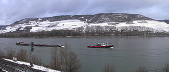 Winter landscape of the Middle Rhine Valley with cargo ships