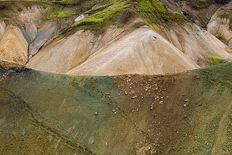 Colorful volcanic hills with mossy green and earthy tones