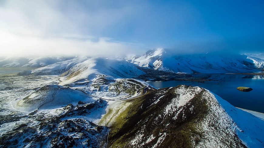 Aerial View of Snowy Mountain Range and Lake