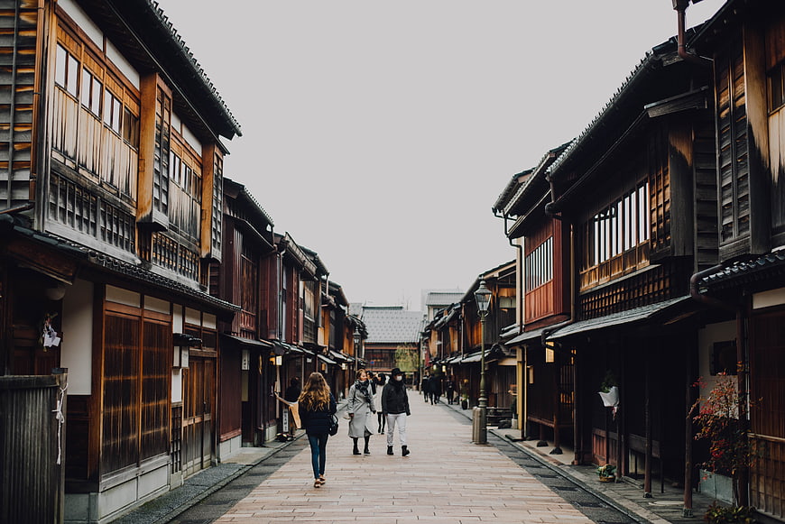 Tourists Walking Down Traditional Japanese Wooden Street