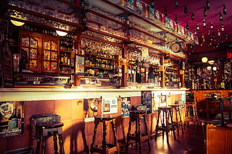 Cozy Traditional Pub Interior With Wooden Bar Counter And Stools