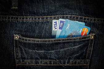 Credit cards in dark denim jeans pocket close-up