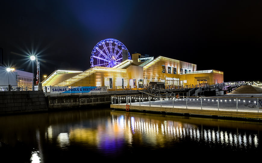 Night view of Helsinki Sompasaari Ferris Wheel and waterfront architecture
