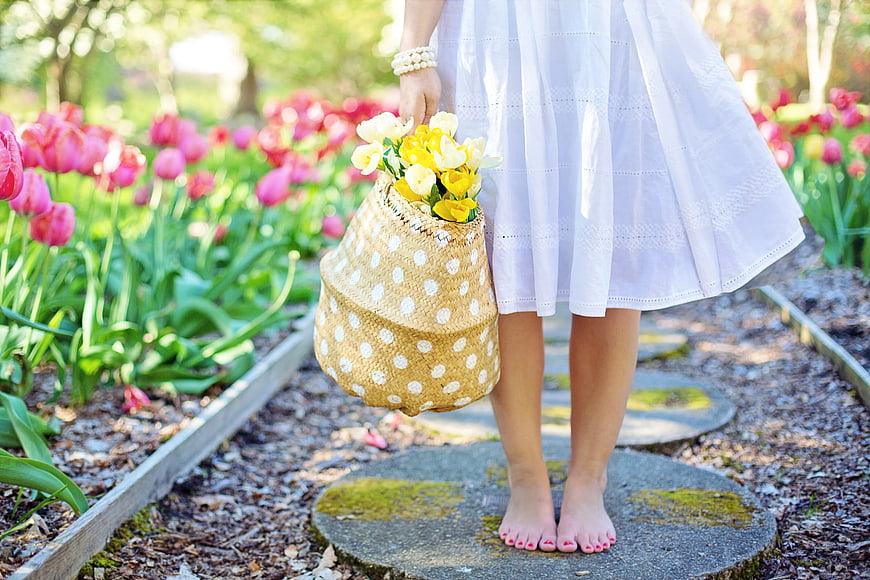 Woman in White Dress Holding Polka Dot Basket with Tulips