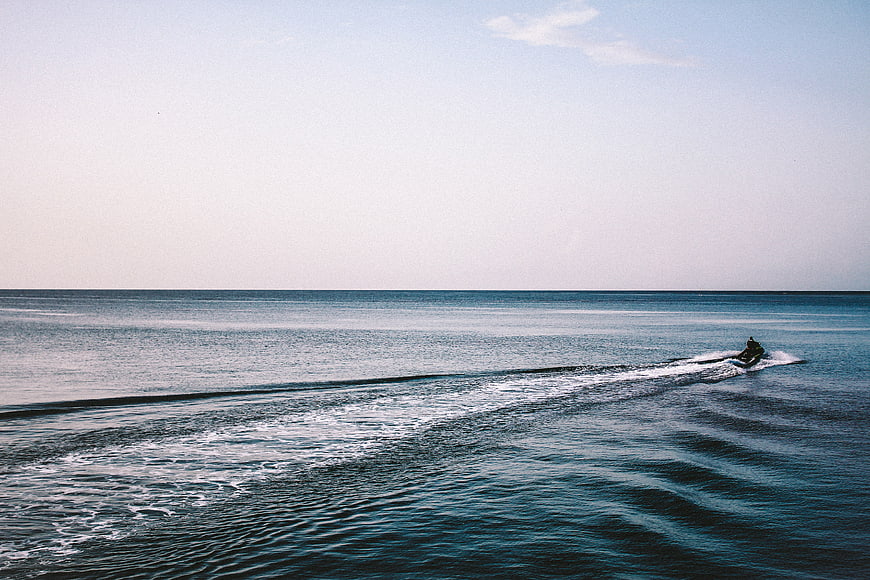 Jet Ski Rider on Calm Blue Ocean with Large Copyspace