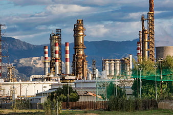 Industrial Oil Refinery Complex With Mountains In Background