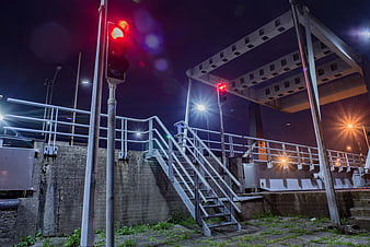 Night shot of metal stairs and red traffic light