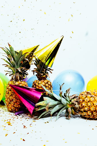 Pineapples Wearing Party Hats With Balloons And Confetti