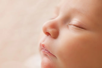 Close-up of sleeping baby face with soft skin texture