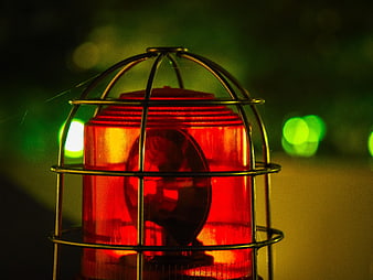 Close-up of red emergency warning light with metal cage