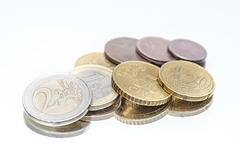 Euro coins on a reflective white surface