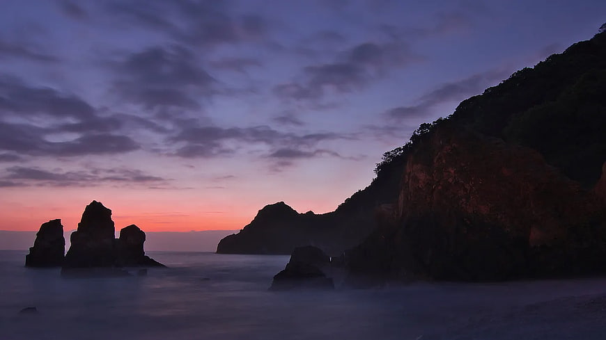 Silhouette of Coastal Cliffs and Sea Stacks at Sunset