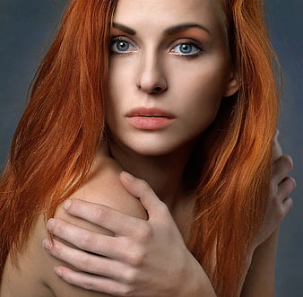 Portrait of a beautiful young redhead woman with blue eyes