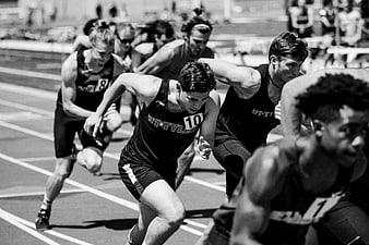 Black and white track sprinters starting race