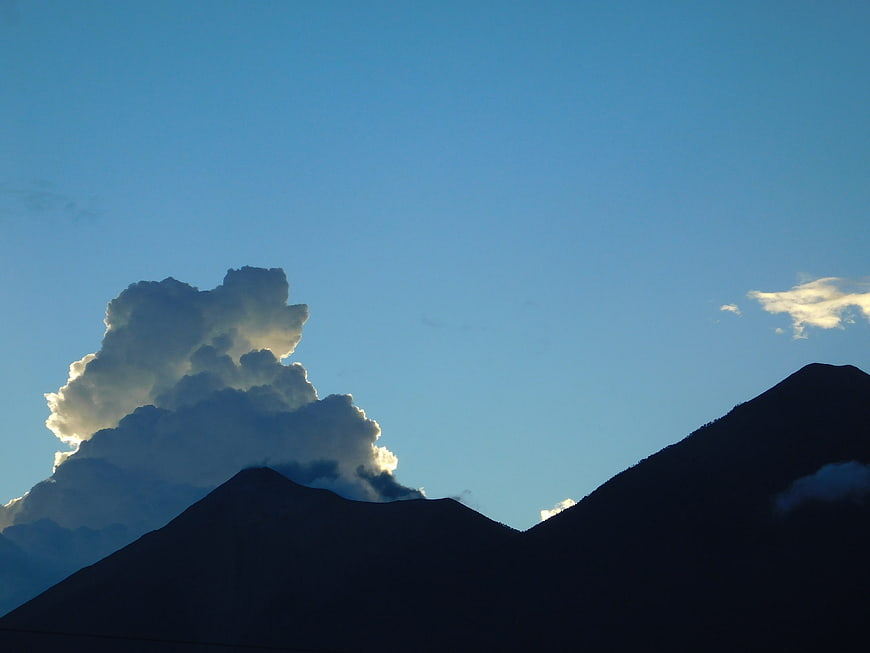Dramatic Cloud Formation Over Silhouetted Mountain Peaks