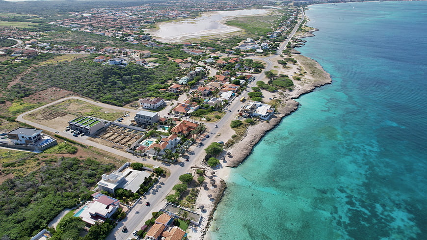 Aerial View of Tropical Coastal Town and Turquoise Ocean