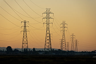 Silhouetted Power Lines Against Golden Sunset Sky