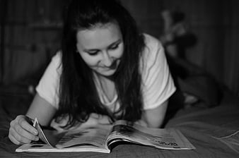 Woman Reading Magazine on Bed