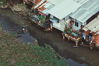 Aerial view of stilt houses along a river in Southeast Asia