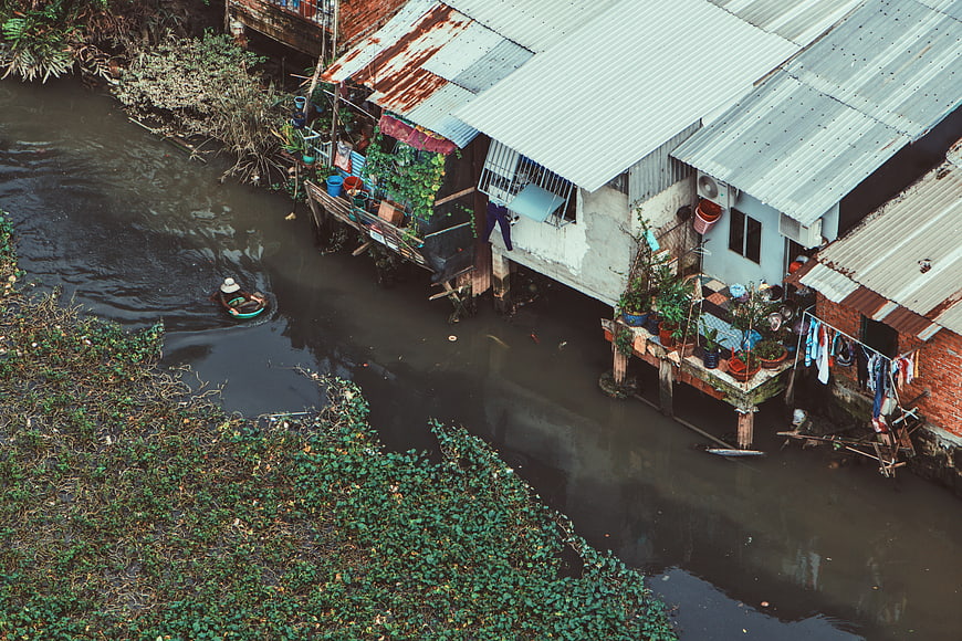 Aerial view of stilt houses along a river in Southeast Asia
