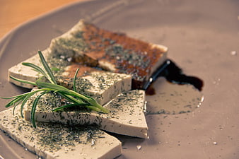 Gourmet Herb-Crusted Tofu Slices With Balsamic Glaze And Rosemary Garnish
