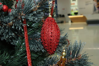 Close-up of Red Glitter Christmas Ornament on Tree