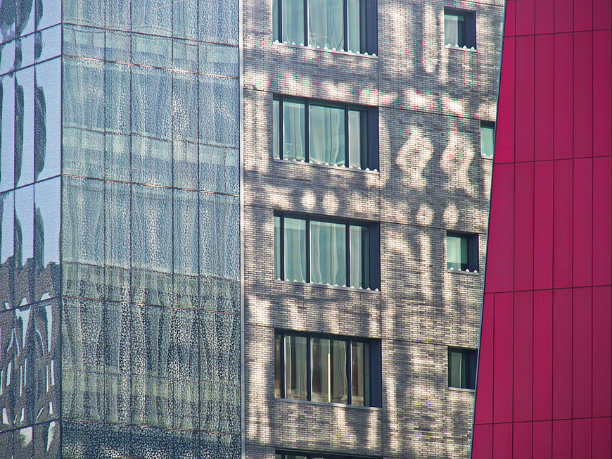 Modern Architecture Facade with Glass, Brick, and Red Panels