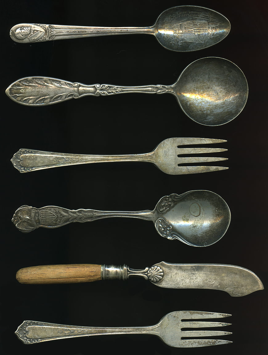 Vintage Silver Cutlery Collection on Black Background