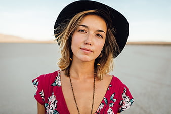 Portrait of Young Woman in Red Floral Dress and Black Hat
