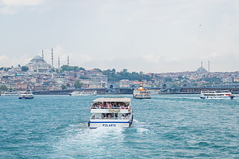 Ferry boat sailing on Bosphorus with Istanbul skyline and mosques