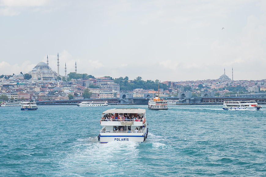 Ferry boat sailing on Bosphorus with Istanbul skyline and mosques