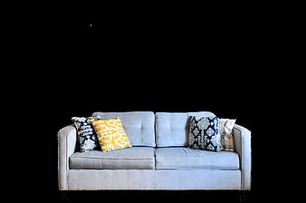 Light Blue Sofa With Decorative Pillows Isolated On Black Background